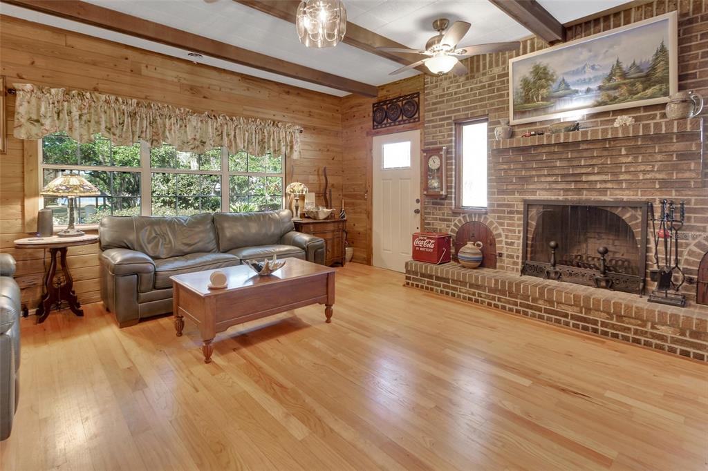 1403 Blackwelder Road De Leon Springs, FL 32130 - Photo 27 of 93 a living room with furniture and a fireplace