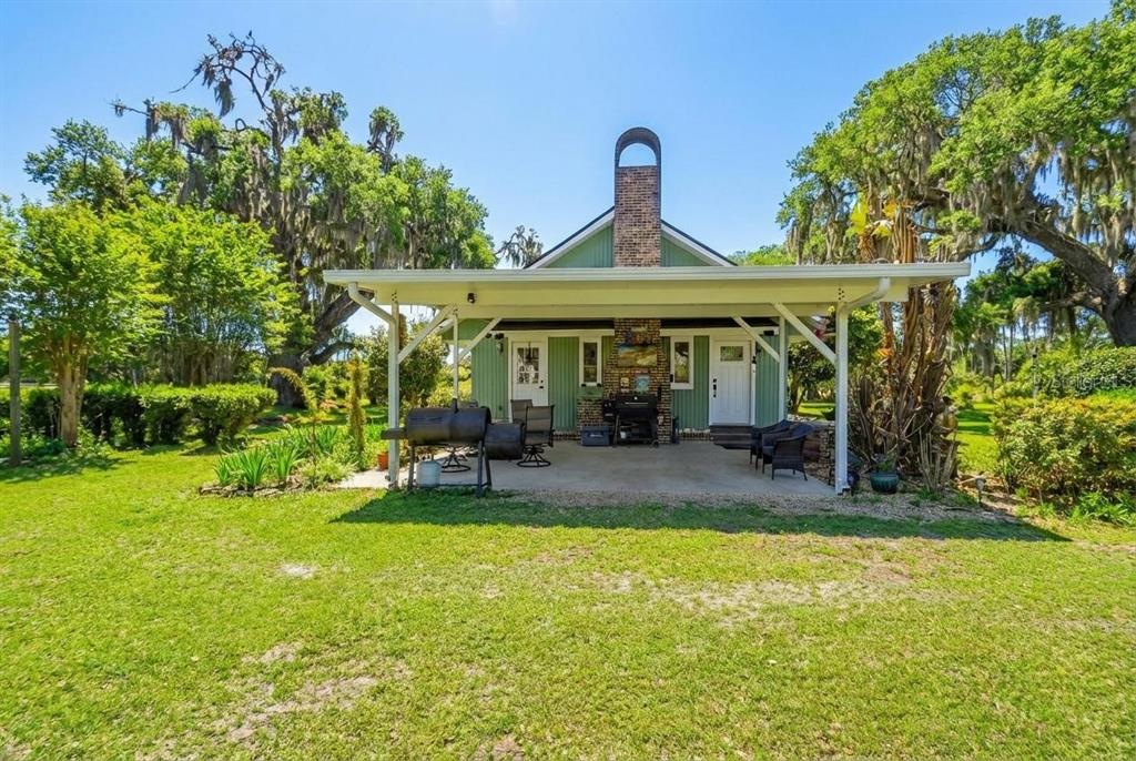 1403 Blackwelder Road De Leon Springs, FL 32130 - Photo 3 of 93 a view of a house with backyard porch and sitting area