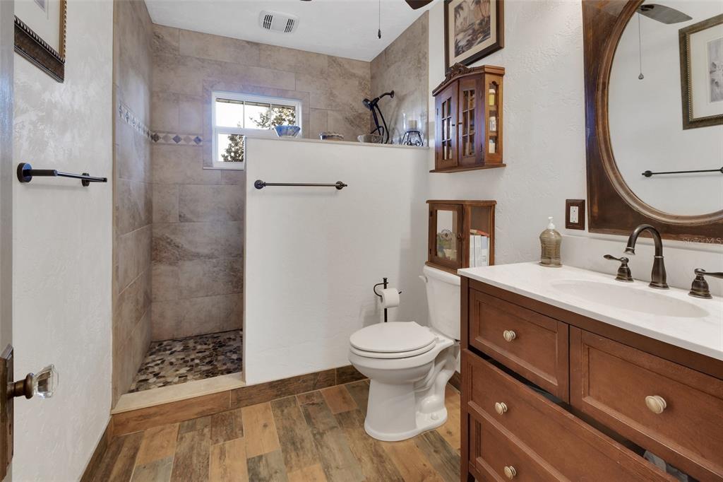 1403 Blackwelder Road De Leon Springs, FL 32130 - Photo 45 of 93 a bathroom with a sink mirror toilet and shower