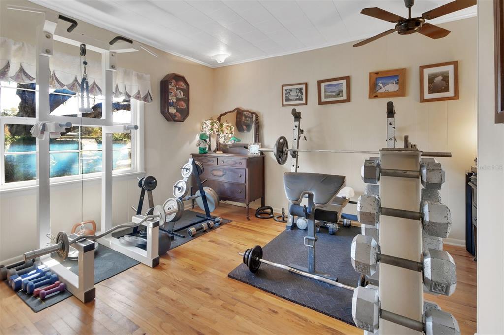 1403 Blackwelder Road De Leon Springs, FL 32130 - Photo 47 of 93 a room with gym equipment and a view of living room