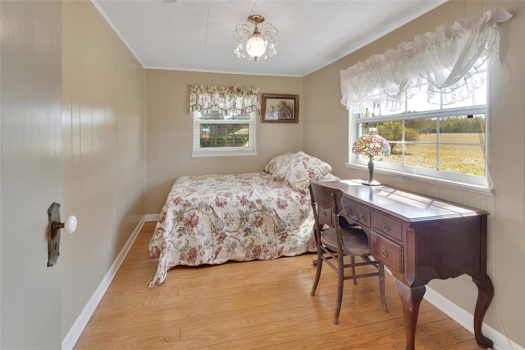 1403 Blackwelder Road De Leon Springs, FL 32130 - Photo 49 of 93 a bedroom with a bed and a table