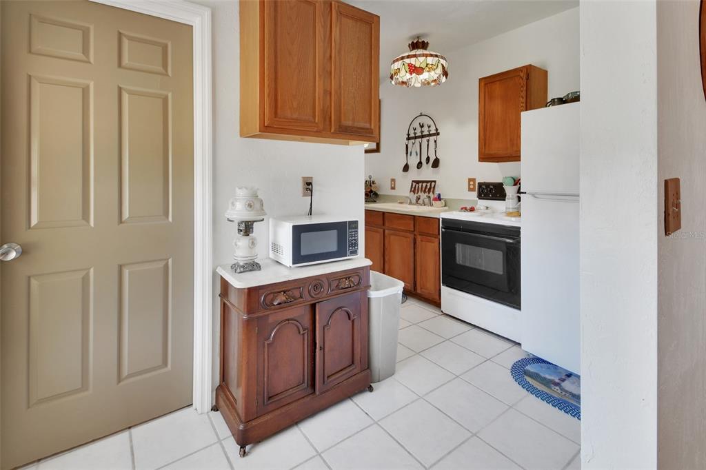 1403 Blackwelder Road De Leon Springs, FL 32130 - Photo 78 of 93 a kitchen with stainless steel appliances granite countertop a stove a sink and a refrigerator