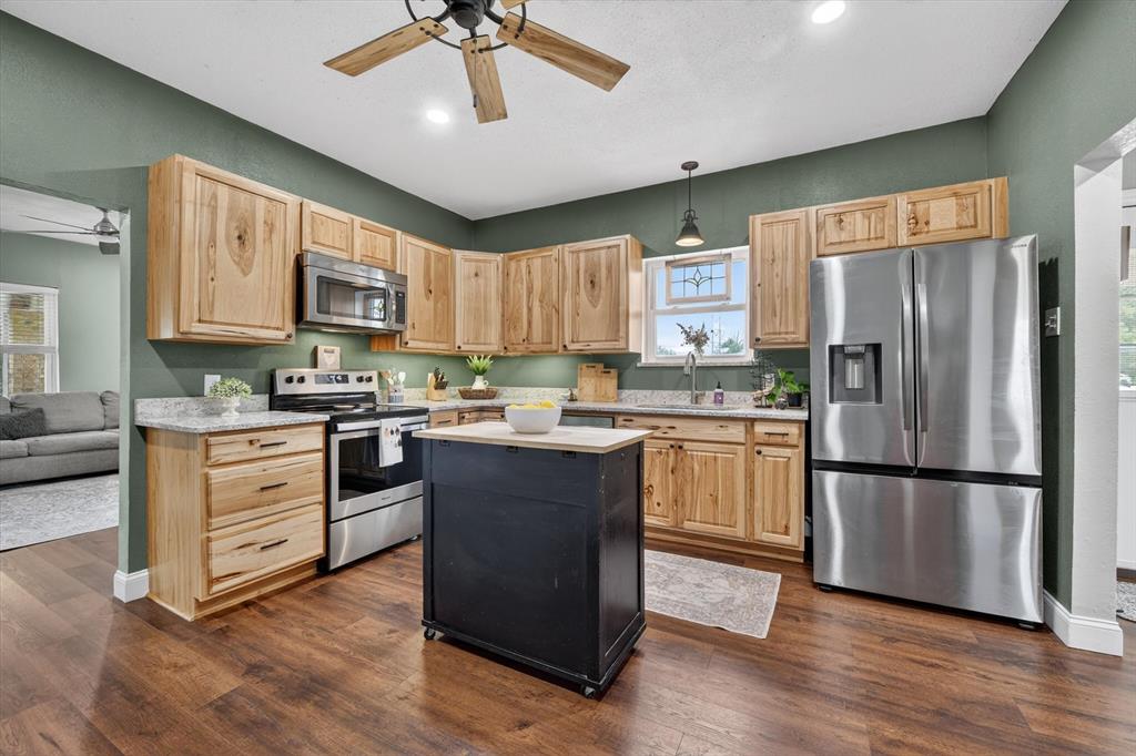 1808 Silver Creek Azle Road Azle, TX 76020 - Photo 12 of 32 a kitchen with stainless steel appliances granite countertop a refrigerator stove and a sink