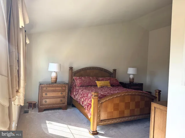 a bedroom with a bed and a lamp with window