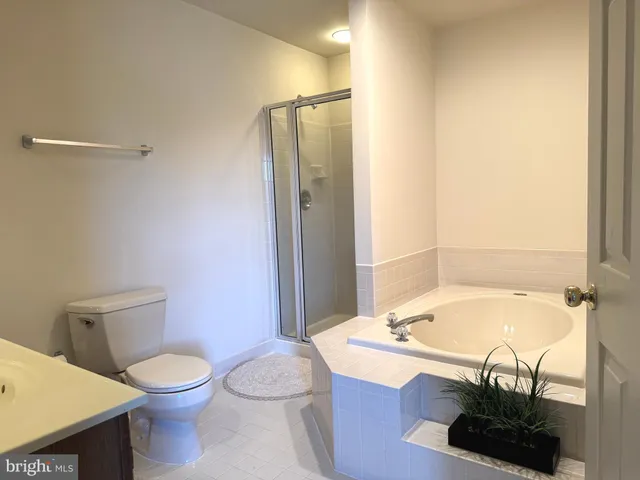 a bathroom with a tub and shower