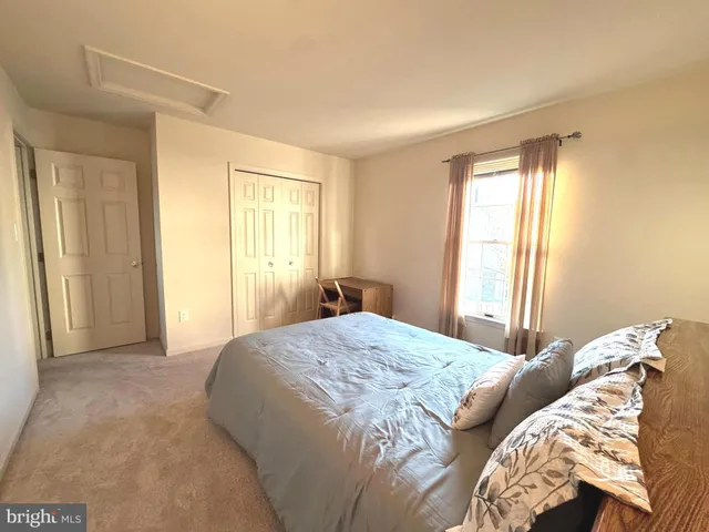 a sitting area with furniture and a wooden floor