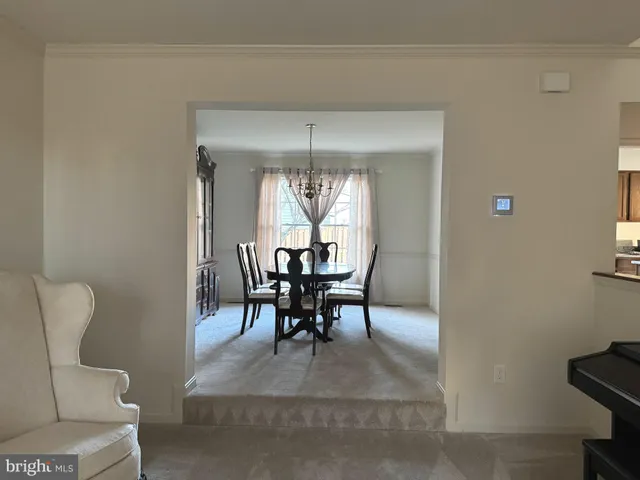 a view of a dining room with furniture and window