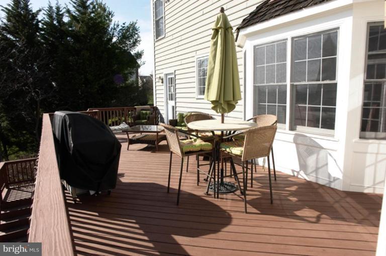 8524 Churchill Downs Road Gaithersburg, MD 20882 - Photo 22 of 30 Custom Deck has stairs to patio and backyard.