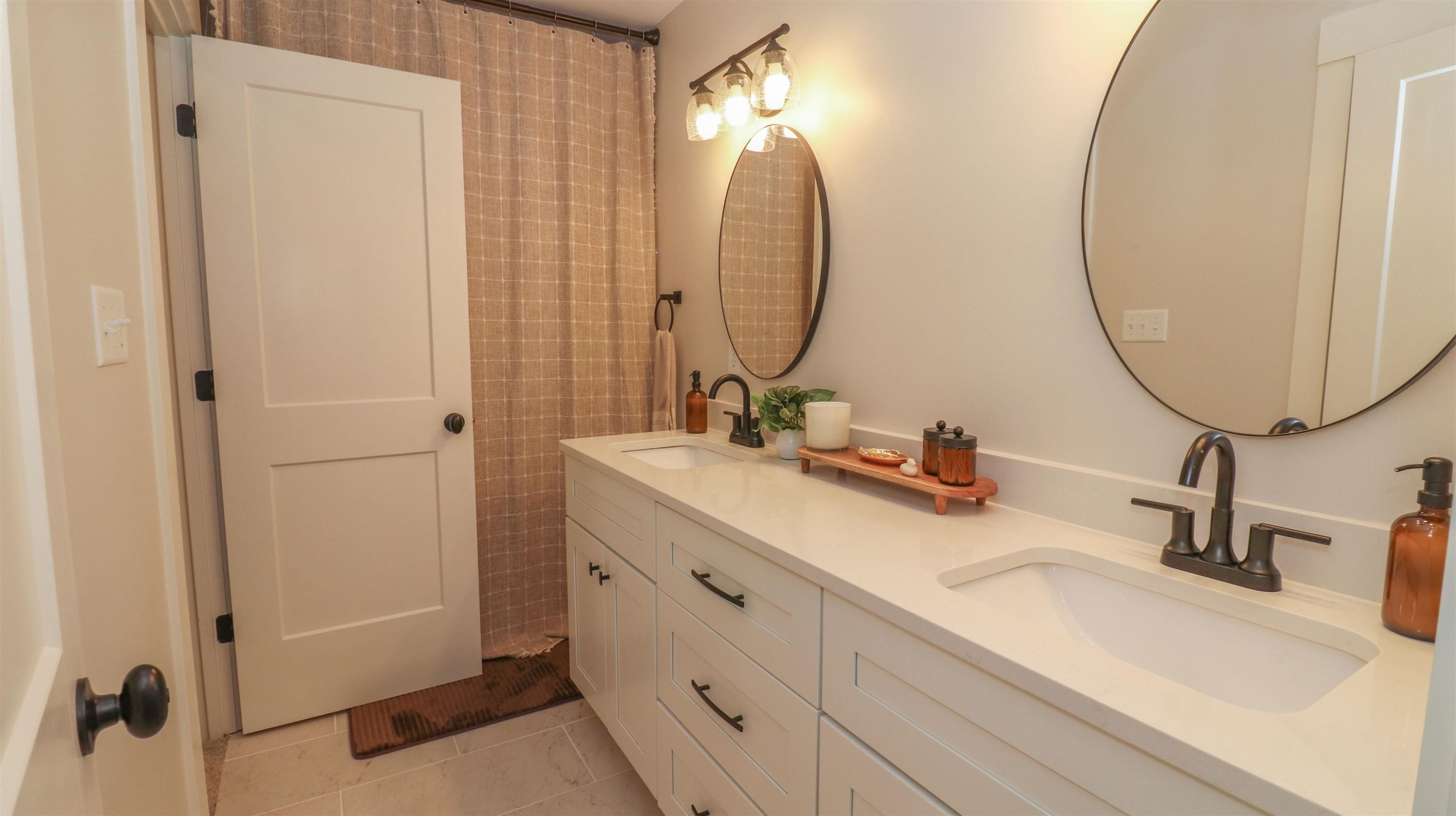 267 West Deaderick Street Jackson, TN 38301 - Photo 16 of 21 a bathroom with a double vanity sink and a mirror
