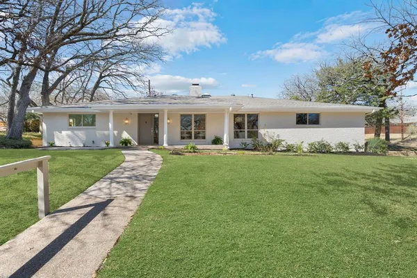 a front view of house with yard and green space