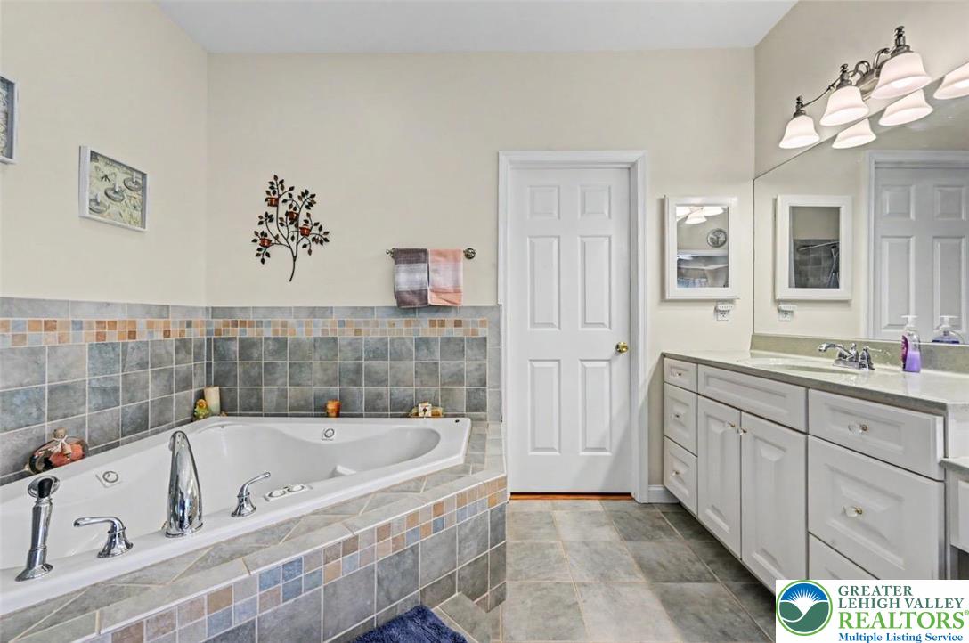 112 Michaels Run Road Stroudsburg, PA 18360 - Photo 37 of 69 The Primary Bath has 9' ceilings, tiled floors and leads to the 10.9 x 7.3 walk-in closet.