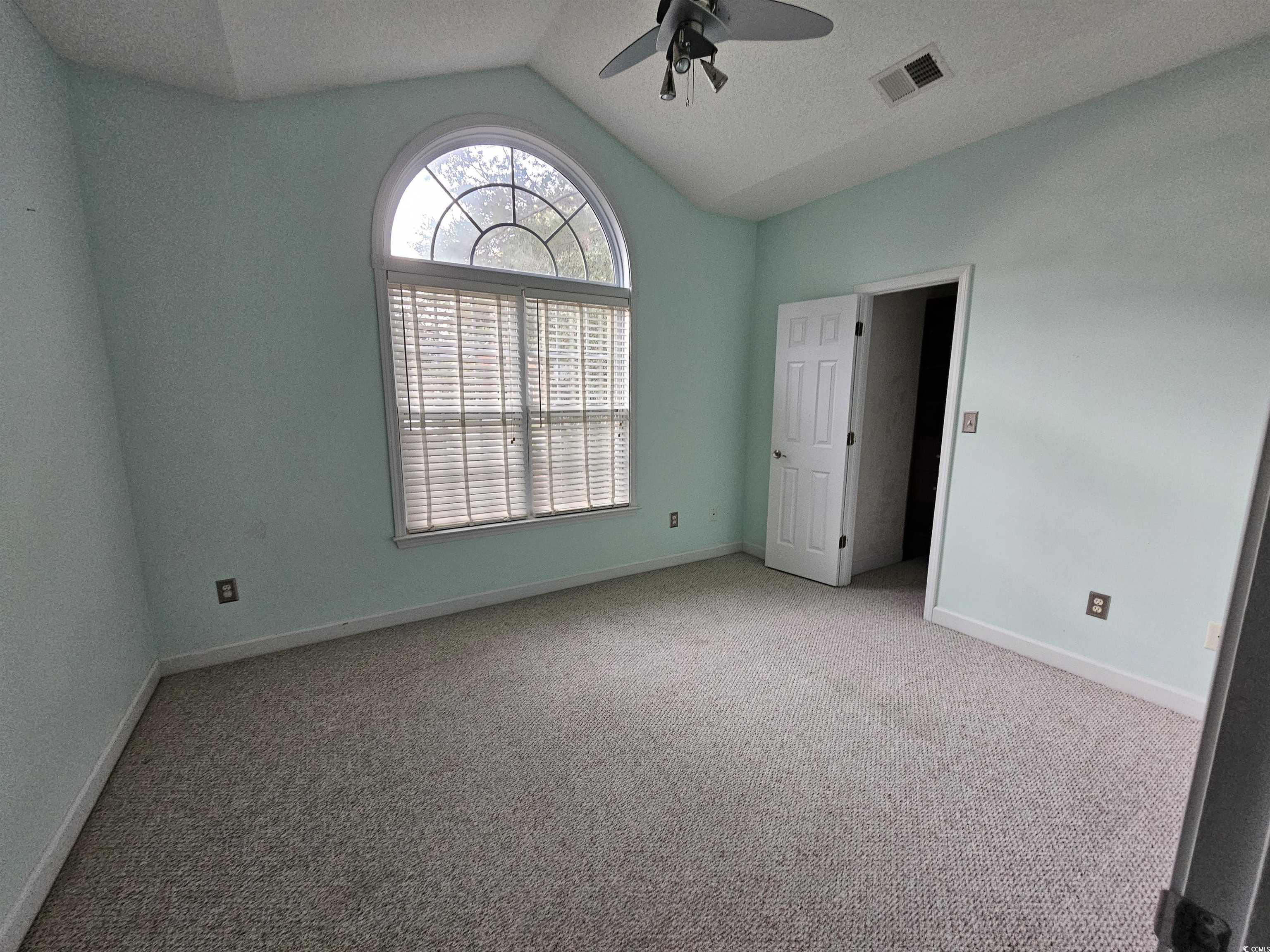 1011 Hillsdale Little River, SC 29566 - Photo 13 of 21 Unfurnished bedroom with carpet floors, vaulted ceiling, and a ceiling fan