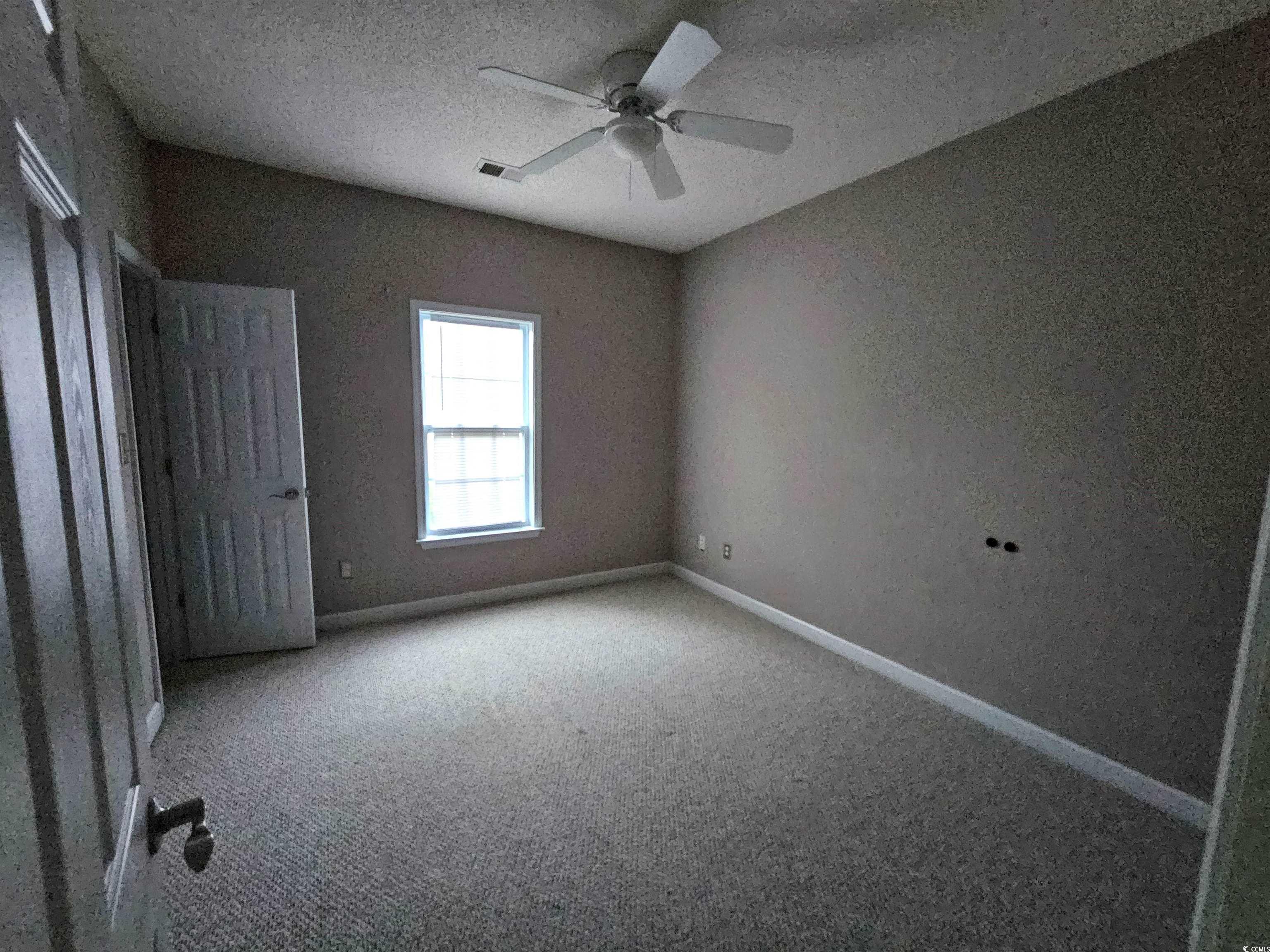 1011 Hillsdale Little River, SC 29566 - Photo 14 of 21 Unfurnished bedroom featuring a textured ceiling, carpet flooring, and ceiling fan