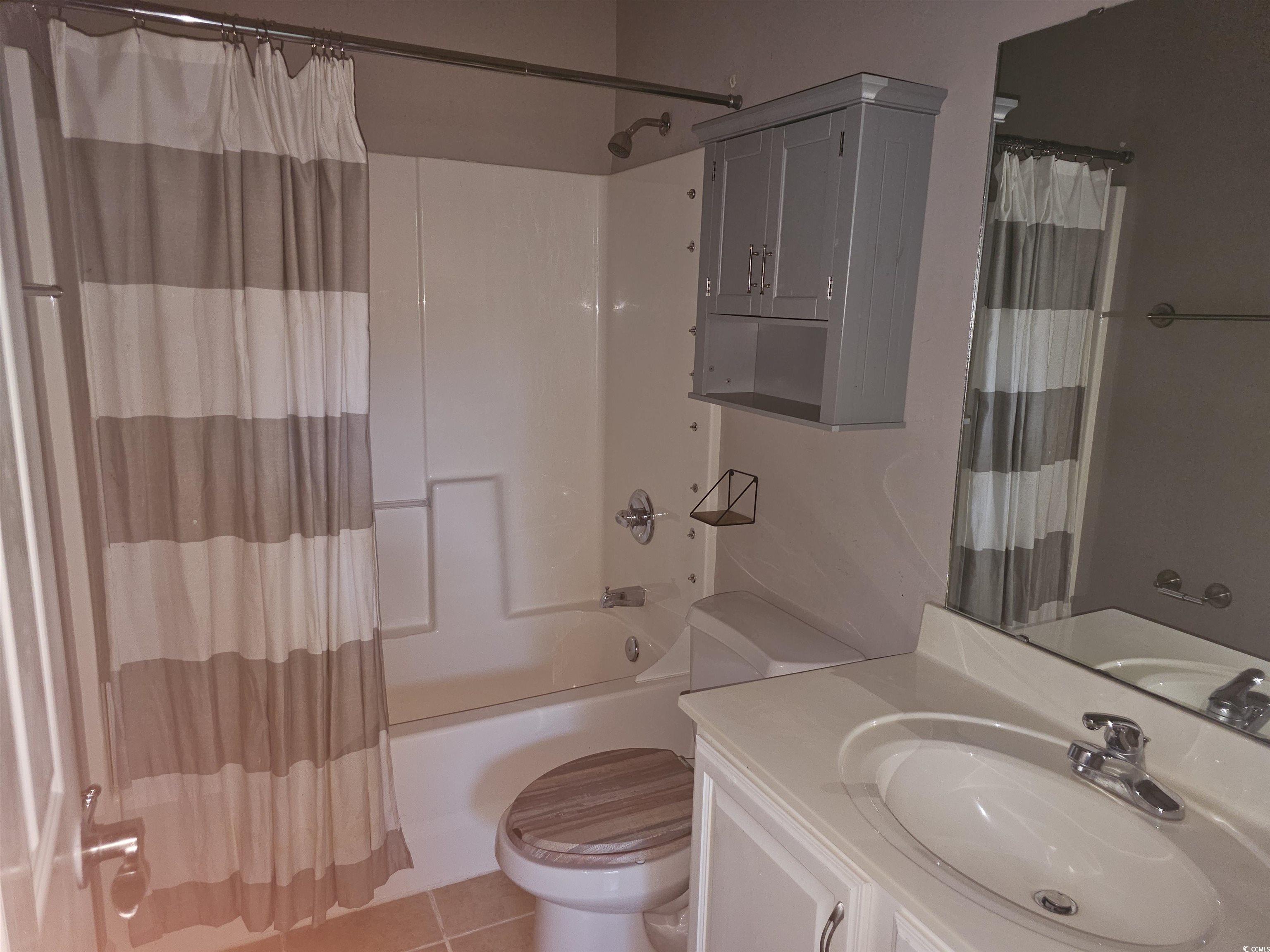 1011 Hillsdale Little River, SC 29566 - Photo 17 of 21 Full bathroom with vanity, light tile patterned floors, and shower / bath combo