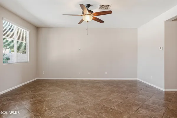 a living room with furniture kitchen view and a large window