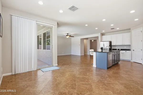 a kitchen with a table and chairs in it