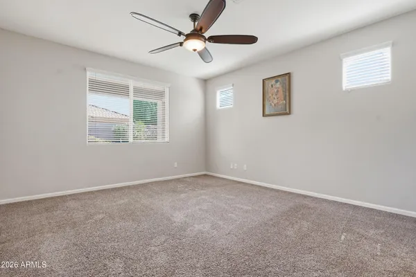 an empty room with closet and windows