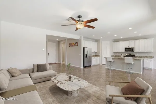 a living room with furniture a lamp and a chandelier