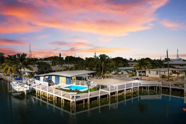 a balcony with couple of table and chairs