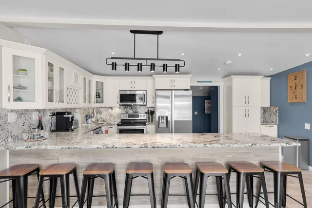 a kitchen with refrigerator and seating