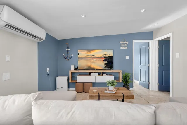a living room with furniture and a flat screen tv