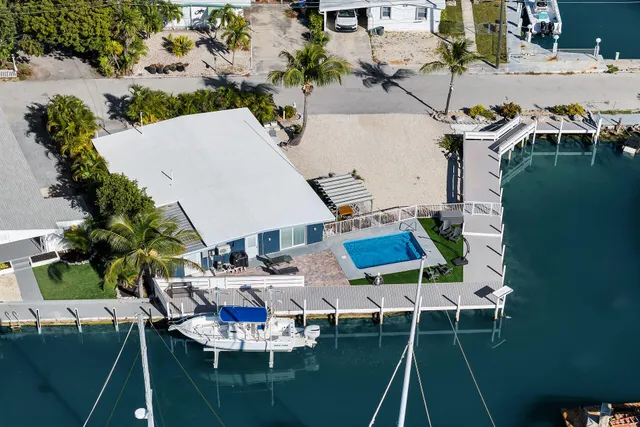 an aerial view of a house with outdoor space pool patio swimming pool and outdoor seating