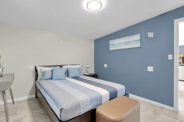 a bathroom with a bathtub shower sink mirror vanity and toilet