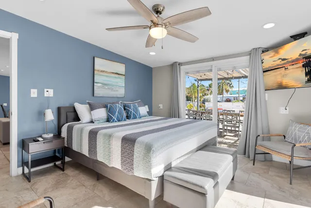 a bedroom with a bed wooden floor and window