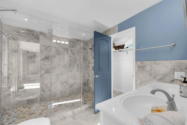 a bathroom with a toilet sink and mirror