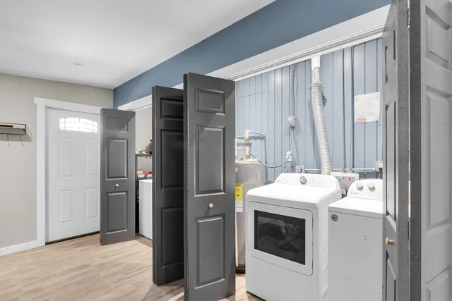 a patio with a table and chairs and potted plants