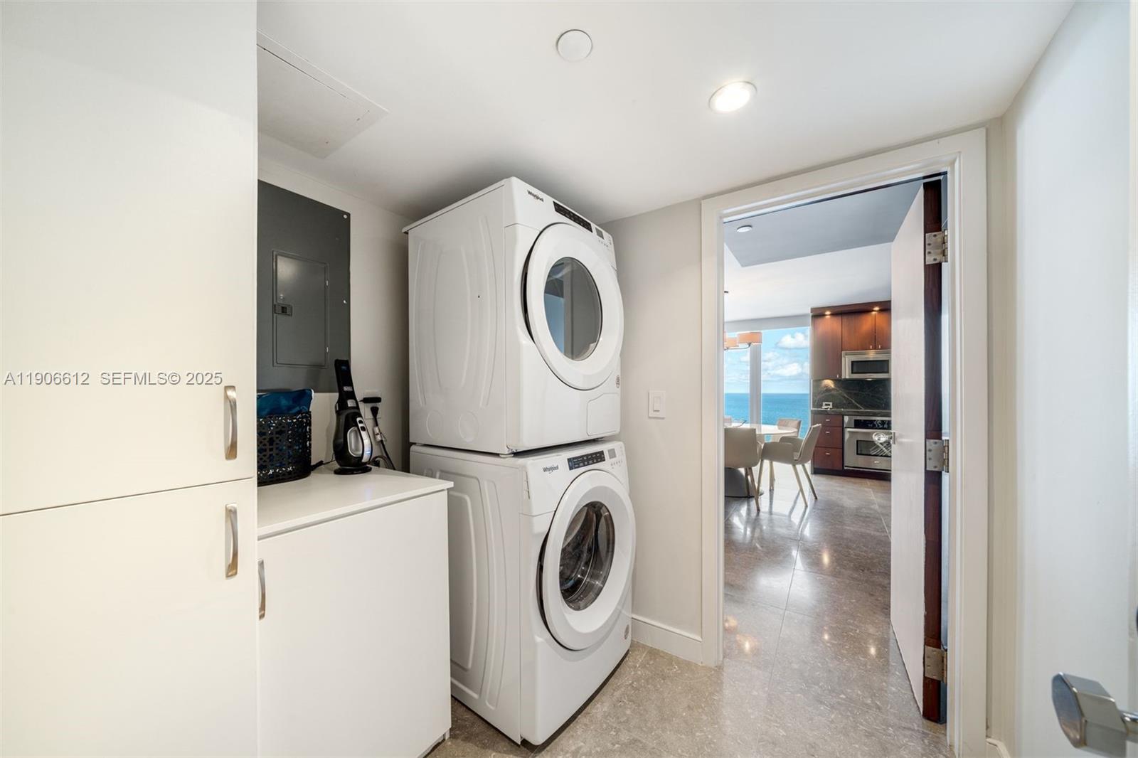 881 Ocean Drive, Unit 26B Key Biscayne, FL 33149 - Photo 18 of 34 a utility room with dryer and washer