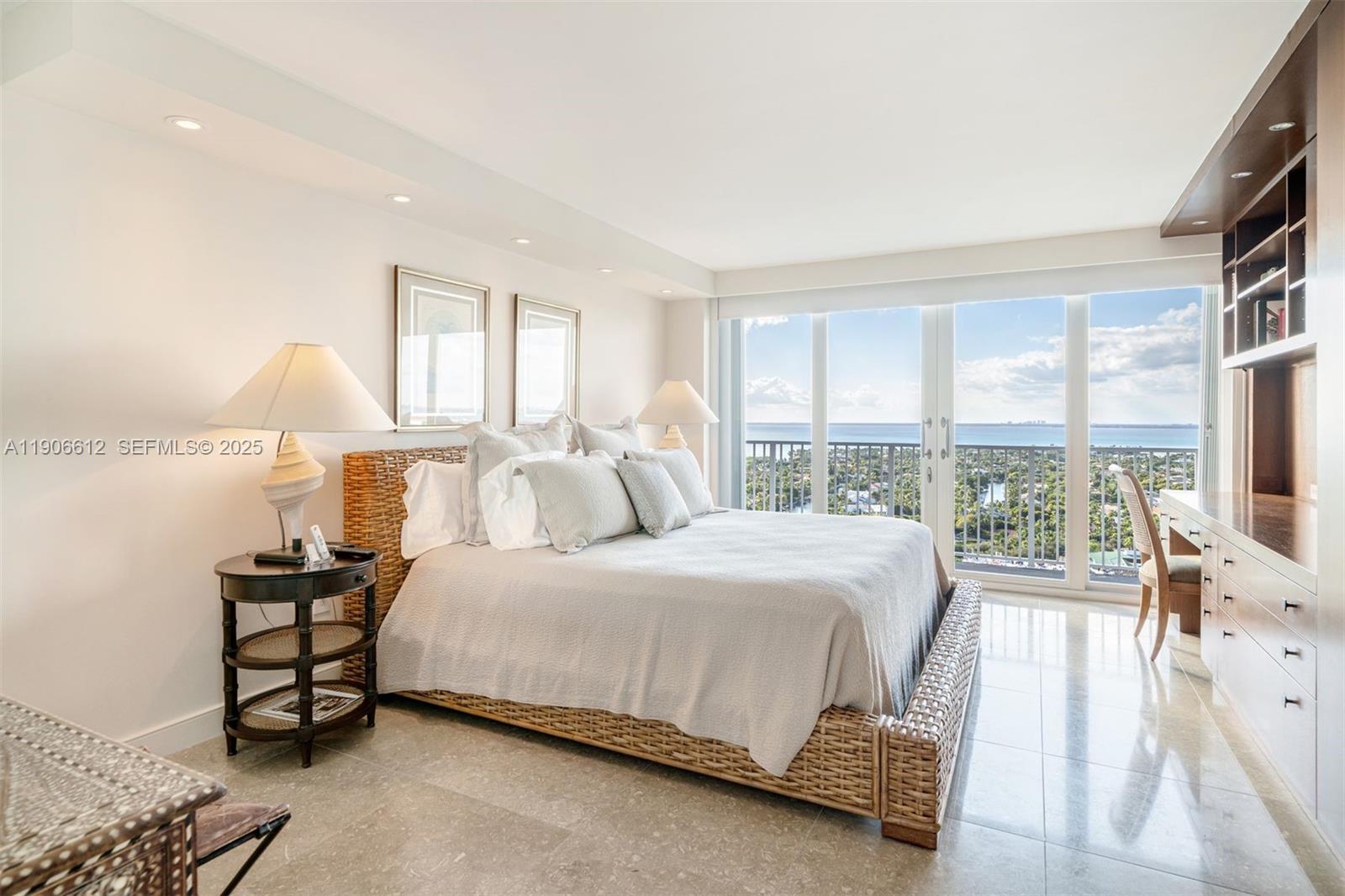 881 Ocean Drive, Unit 26B Key Biscayne, FL 33149 - Photo 19 of 34 a bedroom with a bed and a night stand