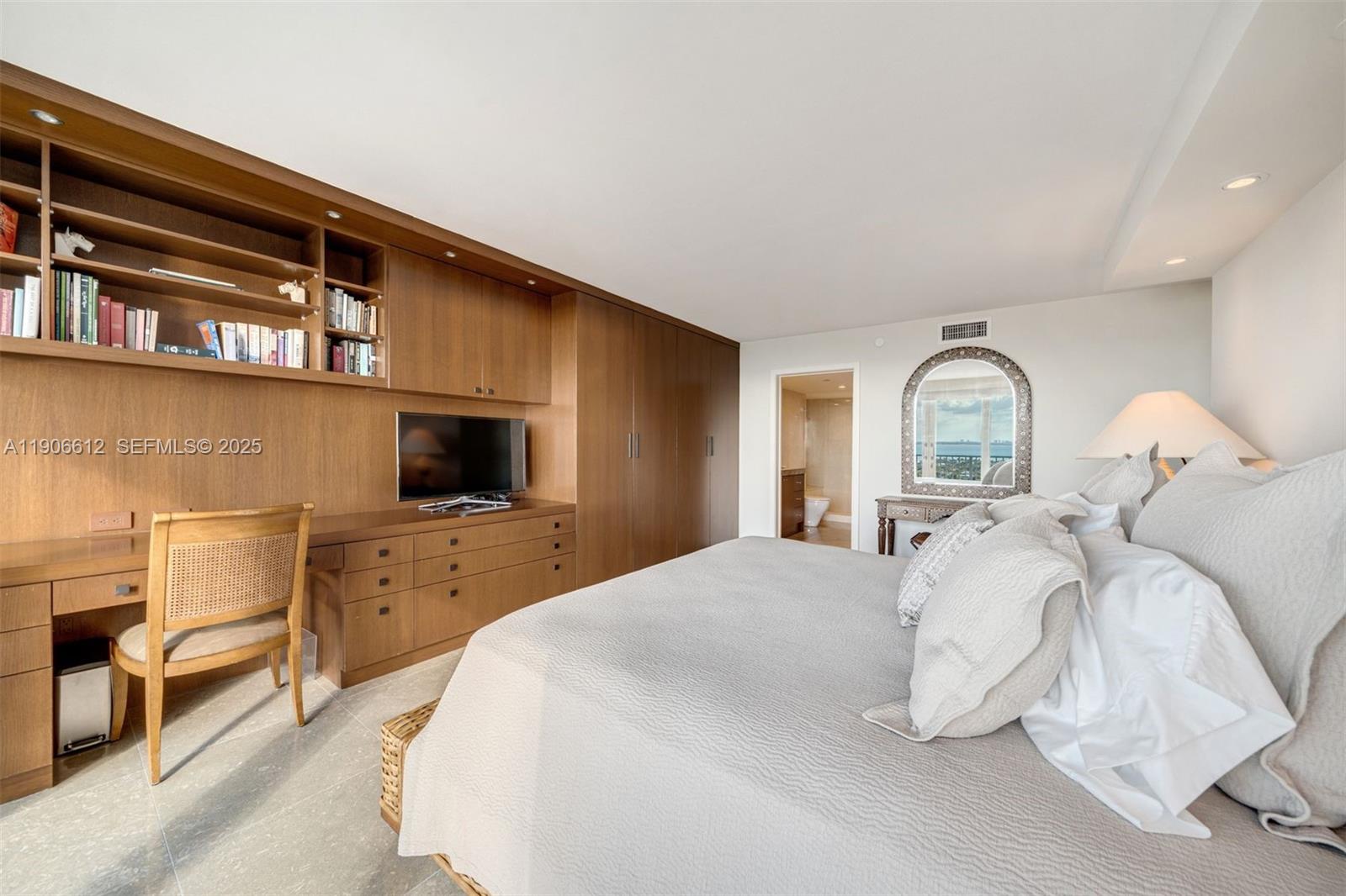 881 Ocean Drive, Unit 26B Key Biscayne, FL 33149 - Photo 22 of 34 a bedroom with a bed and a television