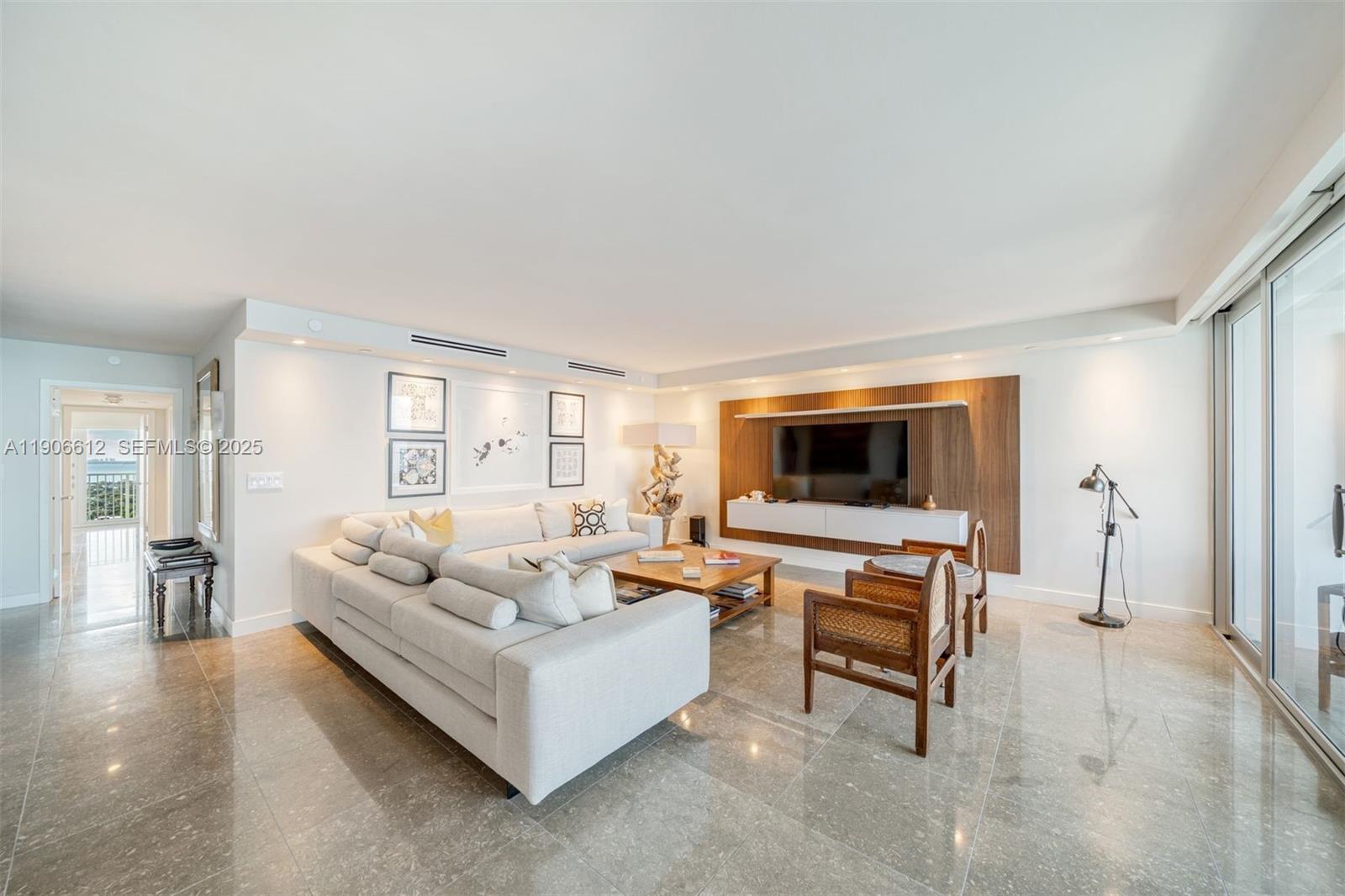 881 Ocean Drive, Unit 26B Key Biscayne, FL 33149 - Photo 3 of 34 a living room with furniture and a flat screen tv