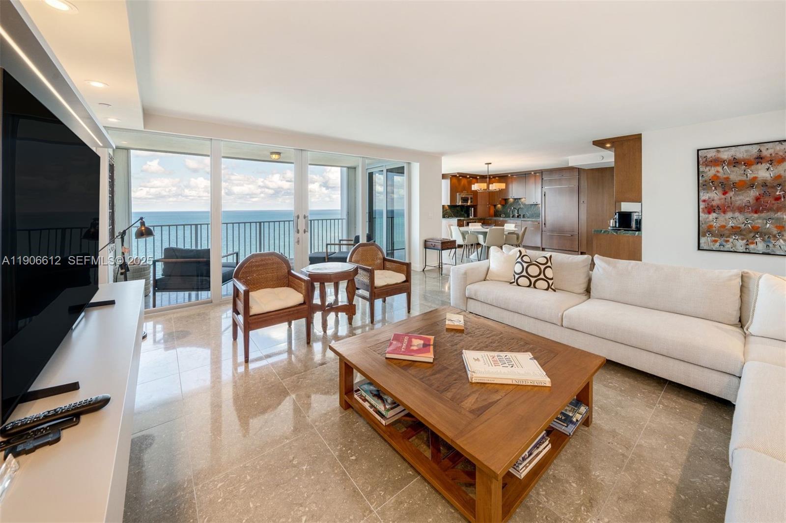 881 Ocean Drive, Unit 26B Key Biscayne, FL 33149 - Photo 5 of 34 a living room with furniture a flat screen tv and a large window
