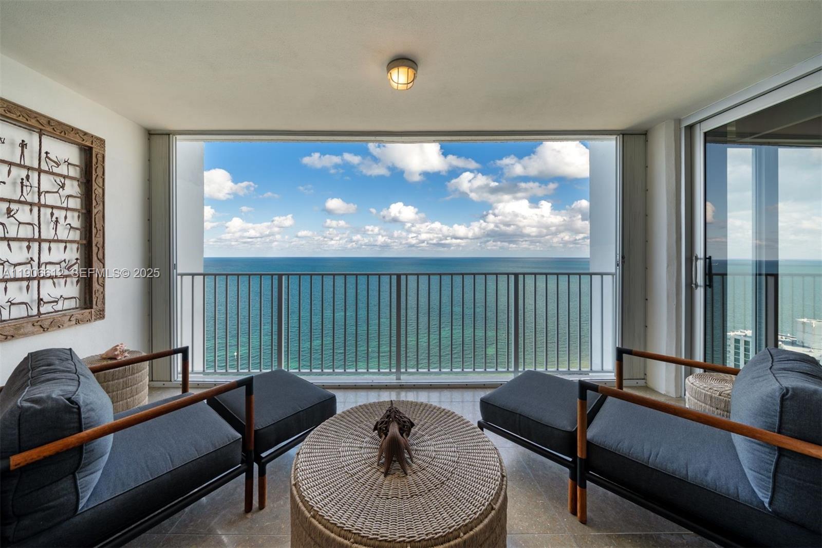 881 Ocean Drive, Unit 26B Key Biscayne, FL 33149 - Photo 7 of 34 a living room with furniture and a large window