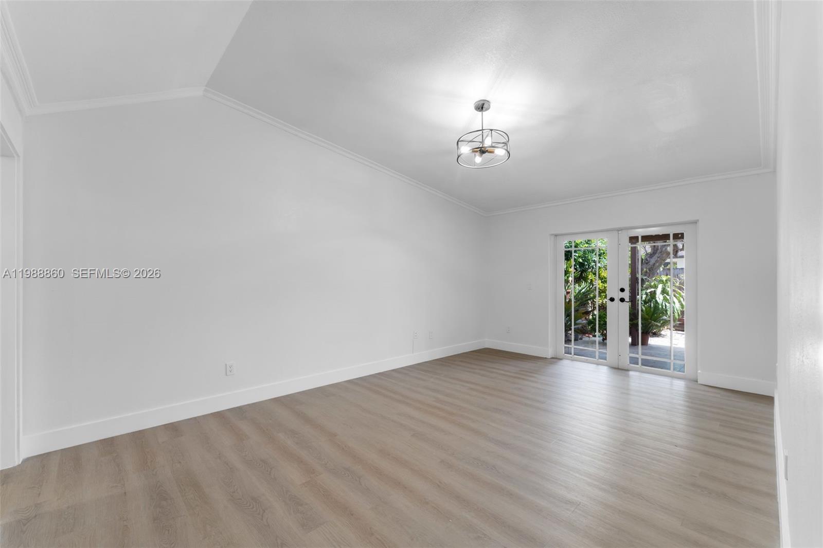 10021 Southwest 145th Place Miami, FL 33186 - Photo 11 of 44 an empty room with wooden floor and windows