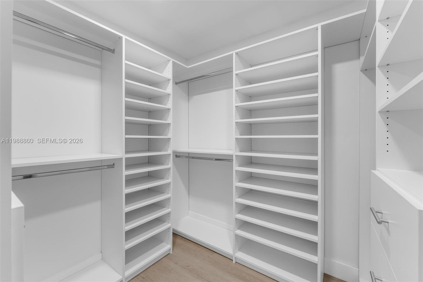 10021 Southwest 145th Place Miami, FL 33186 - Photo 15 of 44 a view of walk in closet with empty racks