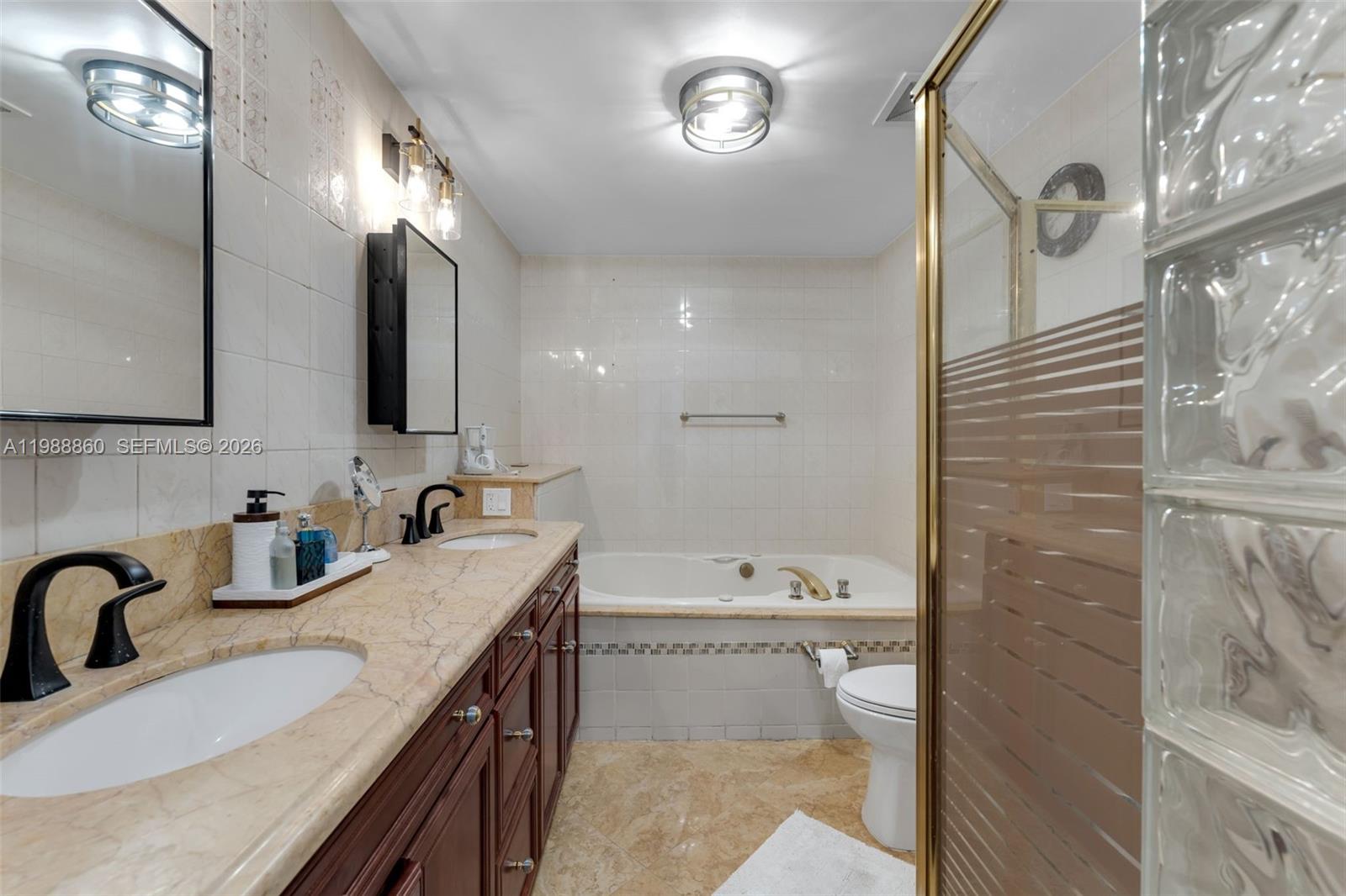 10021 Southwest 145th Place Miami, FL 33186 - Photo 16 of 44 a bathroom with a sink a toilet and shower