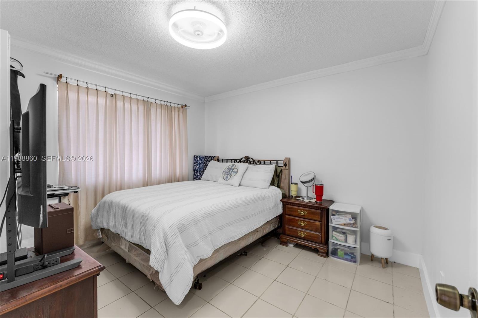 10021 Southwest 145th Place Miami, FL 33186 - Photo 19 of 44 a bedroom with a bed and a flat tv screen