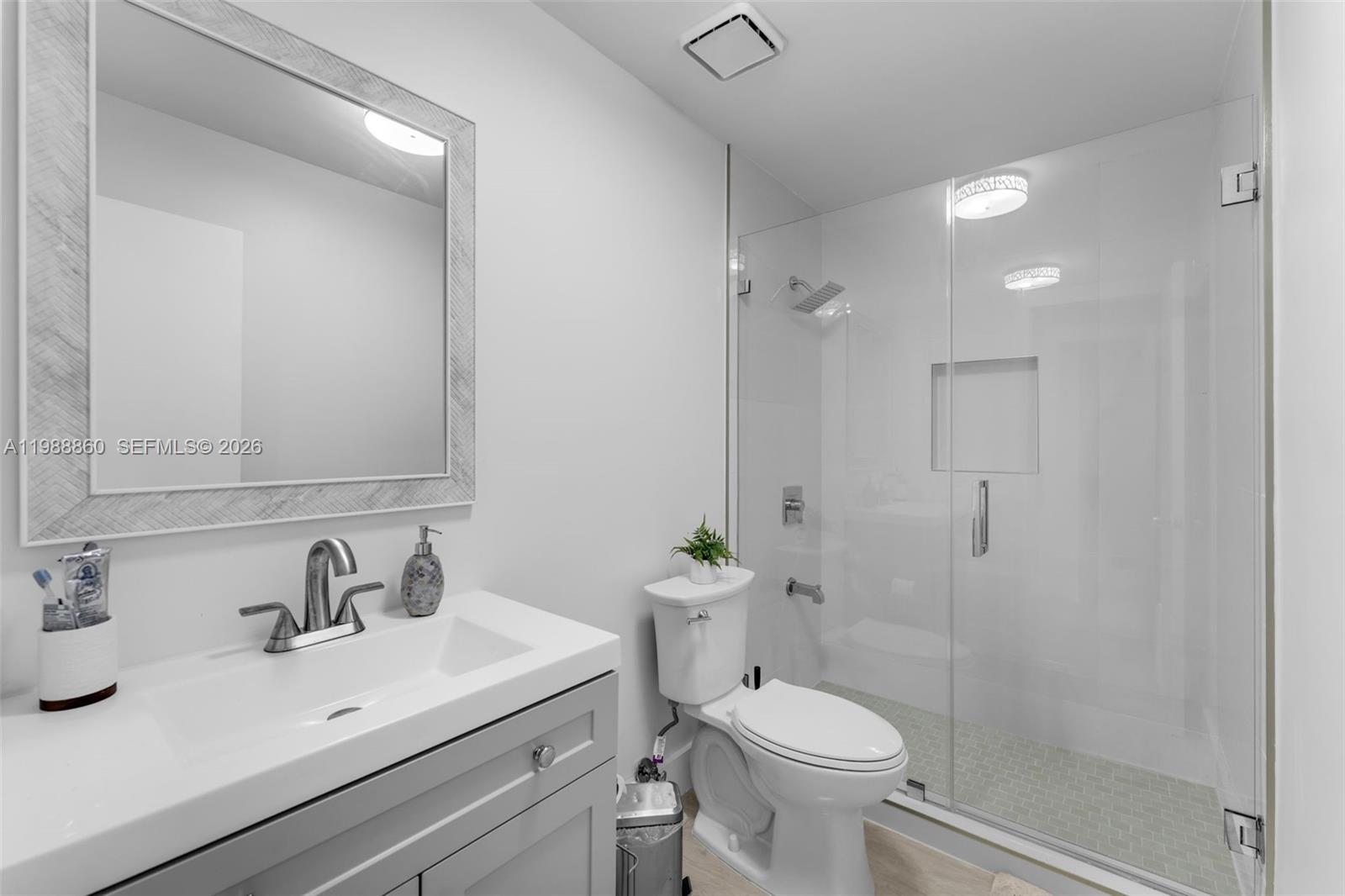 10021 Southwest 145th Place Miami, FL 33186 - Photo 22 of 44 a bathroom with a sink toilet and shower