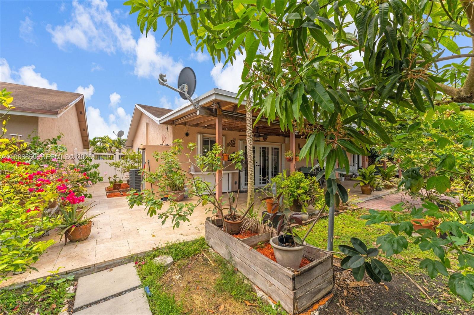 10021 Southwest 145th Place Miami, FL 33186 - Photo 28 of 44 a front view of a house with a yard