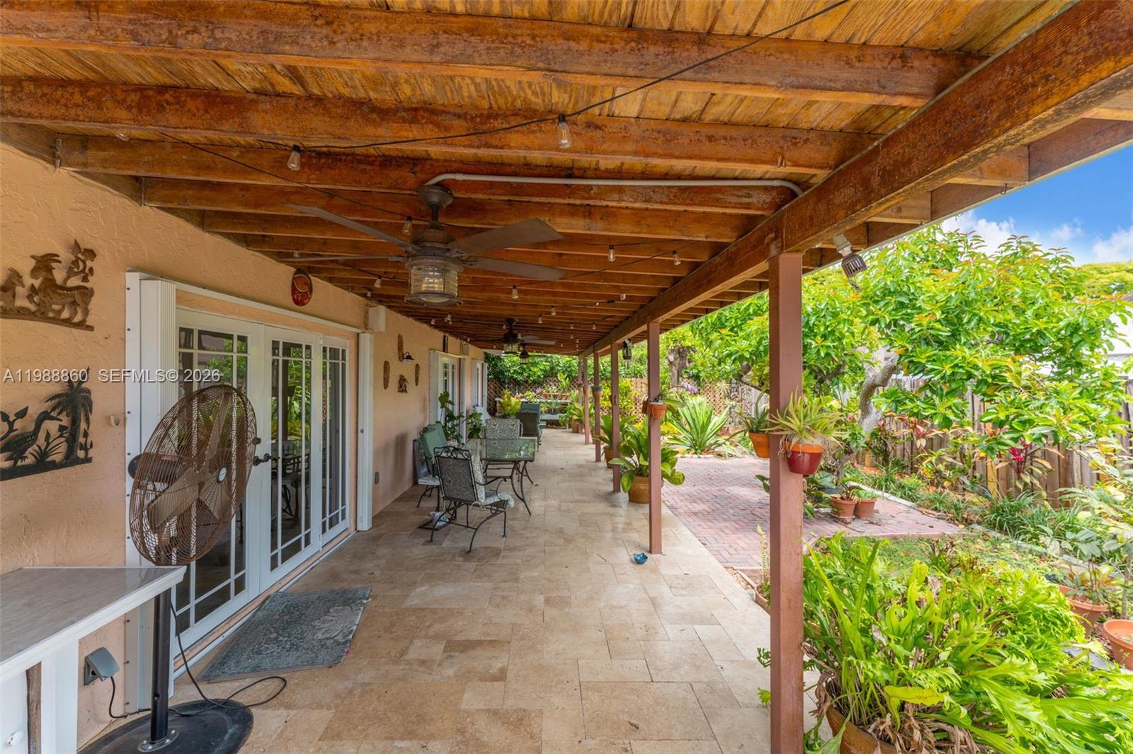 10021 Southwest 145th Place Miami, FL 33186 - Photo 29 of 44 a view of a porch with furniture and a backyard