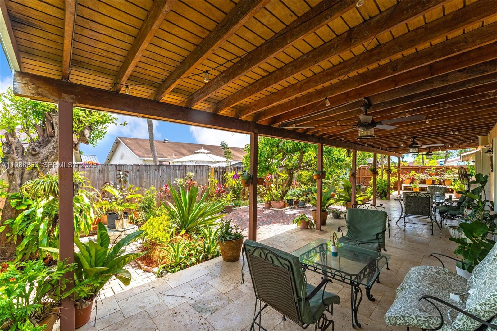 10021 Southwest 145th Place Miami, FL 33186 - Photo 30 of 44 a patio with yard glass top table and chairs