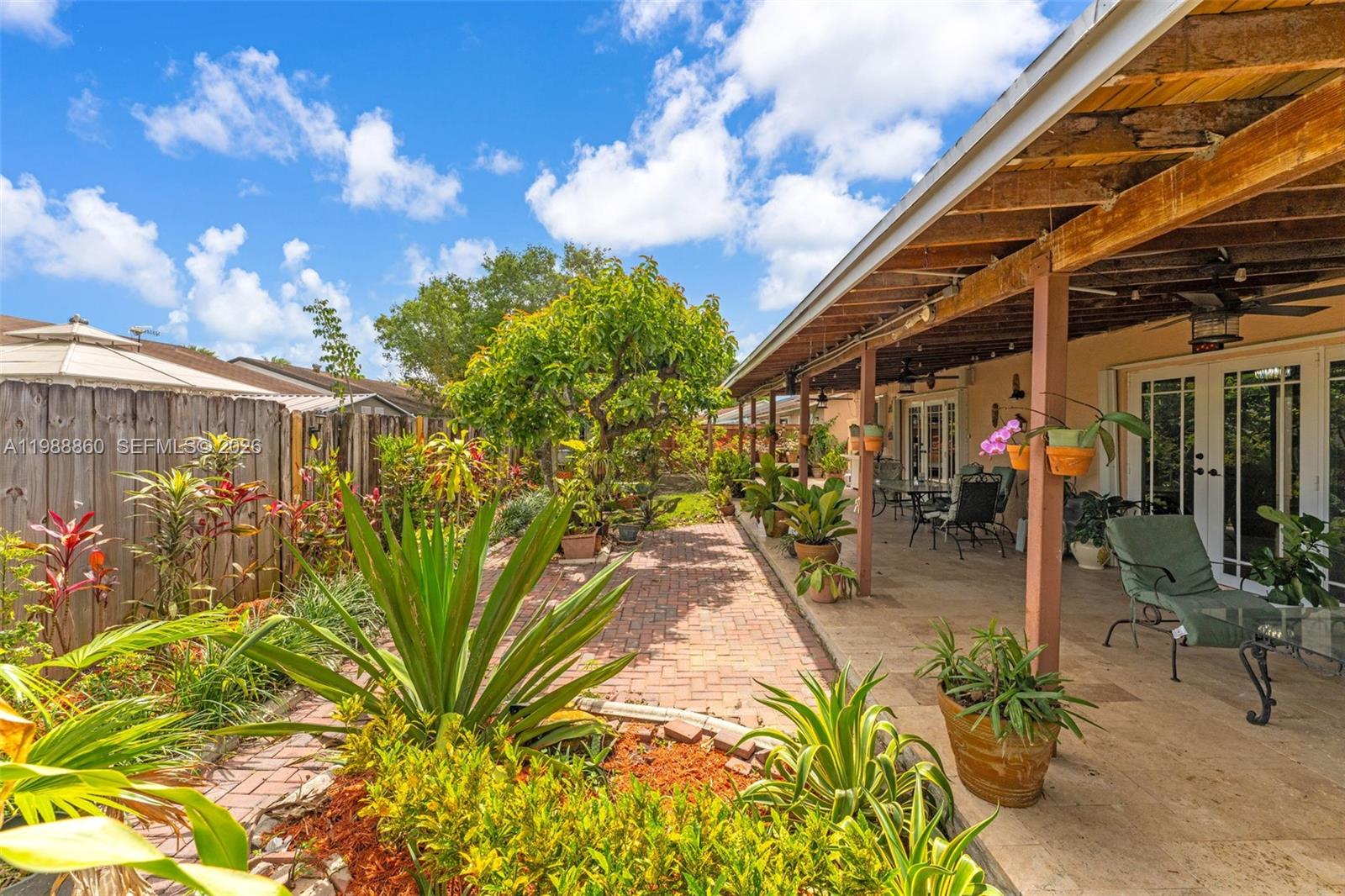 10021 Southwest 145th Place Miami, FL 33186 - Photo 31 of 44 a view of a porch with potted plants