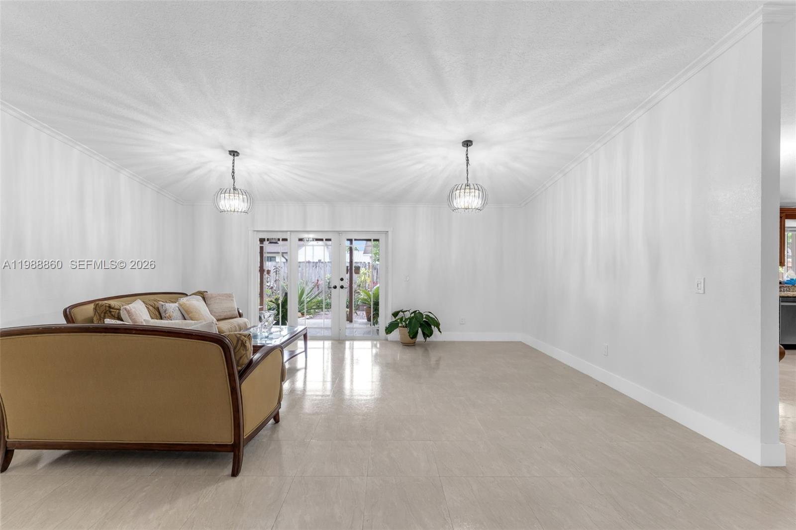 10021 Southwest 145th Place Miami, FL 33186 - Photo 4 of 44 a living room with furniture and a chandelier