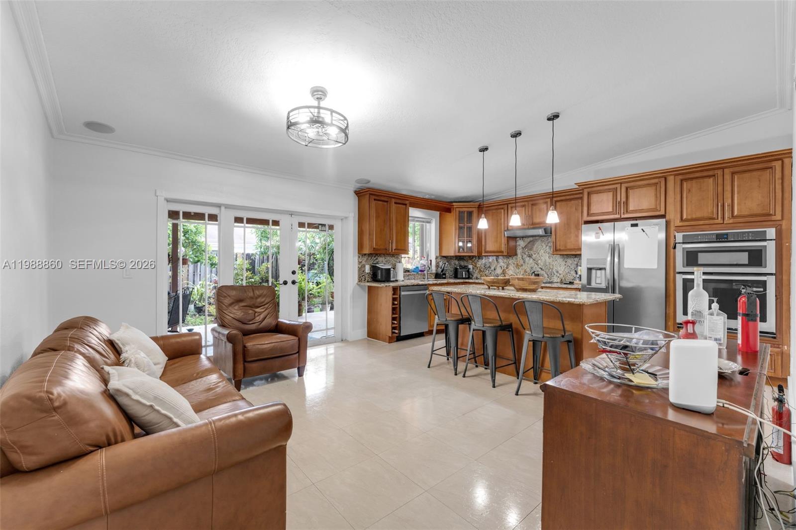 10021 Southwest 145th Place Miami, FL 33186 - Photo 7 of 44 a living room with fireplace furniture and a large window