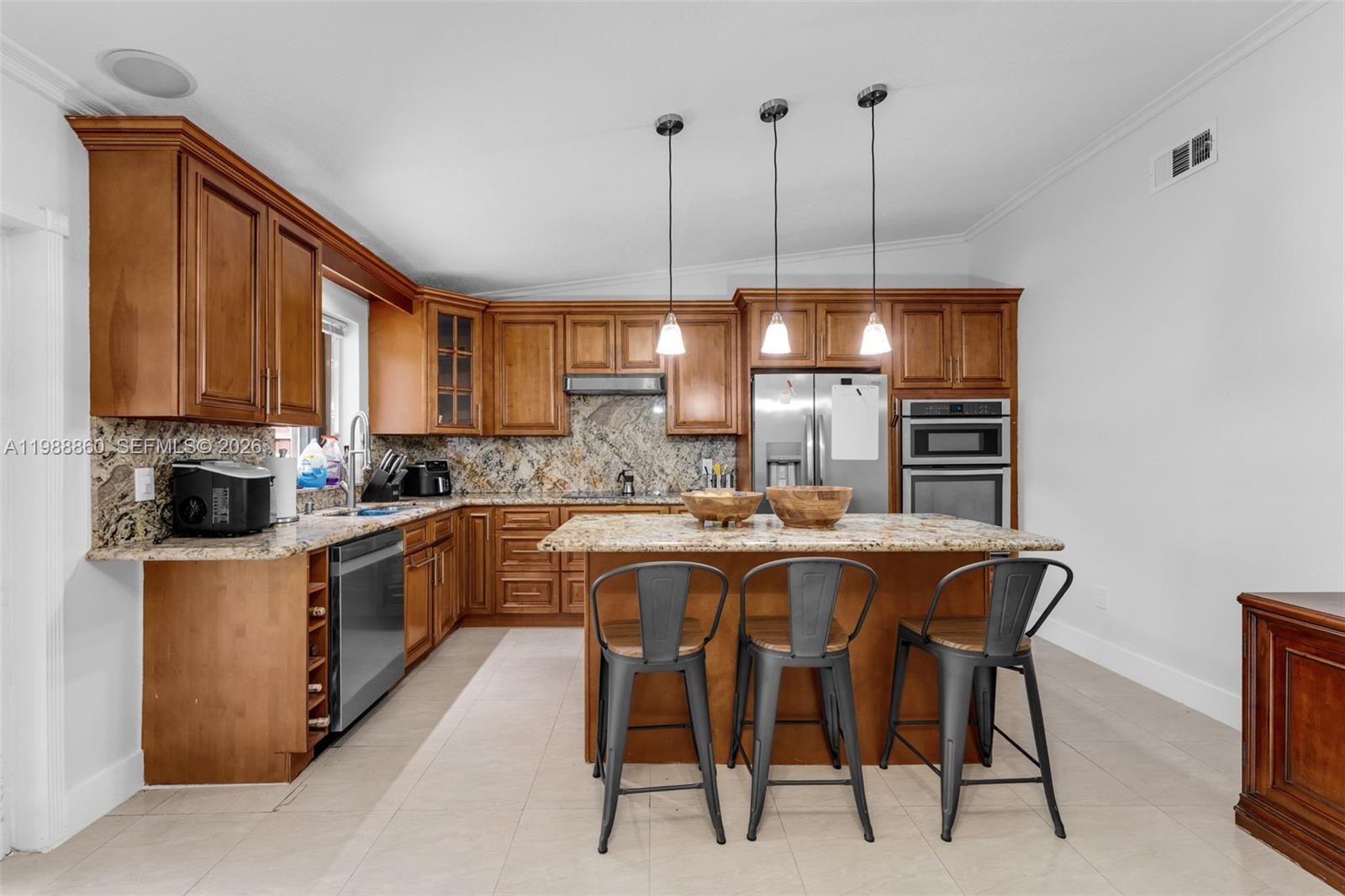 10021 Southwest 145th Place Miami, FL 33186 - Photo 8 of 44 a kitchen with stainless steel appliances granite countertop a sink a stove and a wooden floors