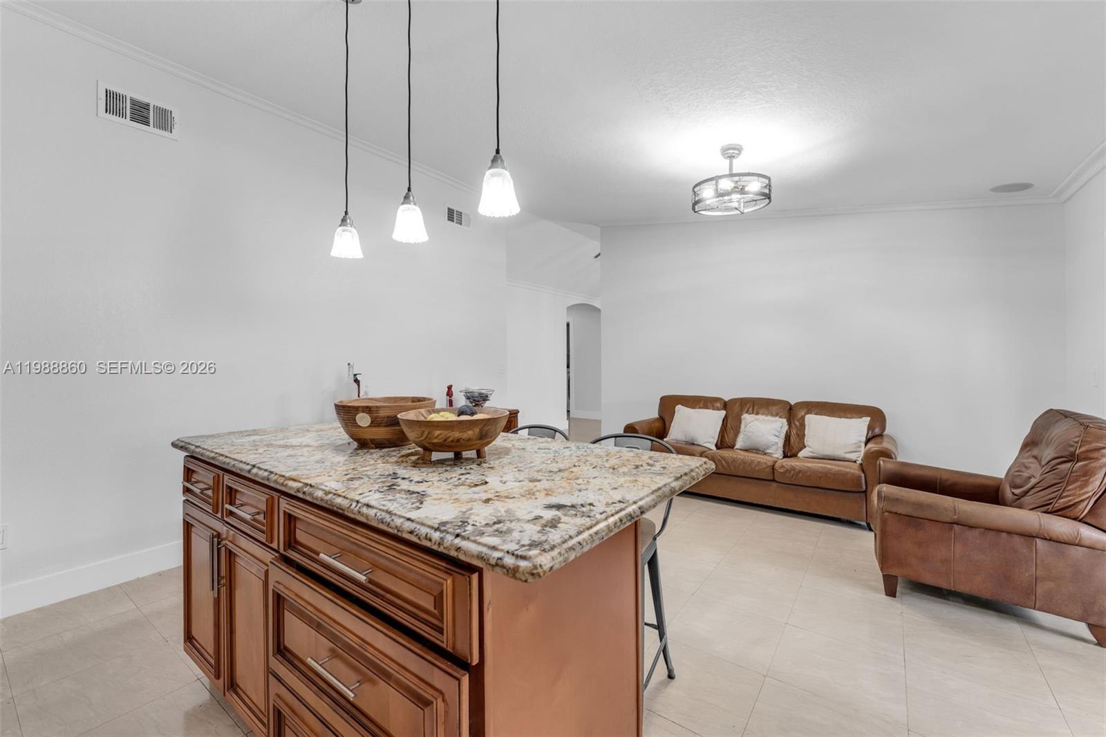 10021 Southwest 145th Place Miami, FL 33186 - Photo 10 of 44 a view of kitchen island with stainless steel appliances granite countertop living room