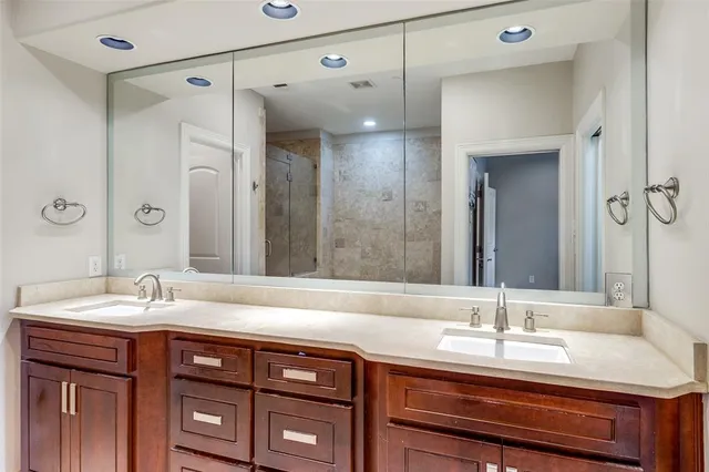 a bathroom with a sink double vanity and a mirror